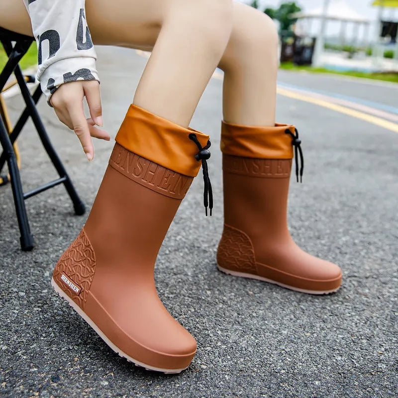 Women's solid colour PVC rain boots with non-slip soles in apricot, black, brown, or pink