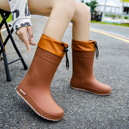 Women's solid colour PVC rain boots with non-slip soles in apricot, black, brown, or pink