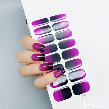 Sheet of 16 small design nail art stickers including cross, rose, tulip and marble patterns.