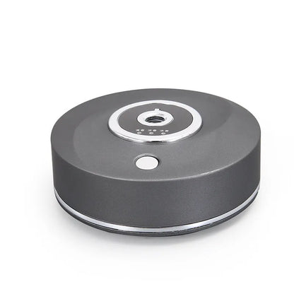 Black plastic USB-powered vehicle mounted aromatherapy machine with anti-slip pad on a car dashboard.