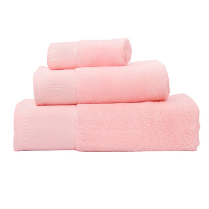 Three-piece cotton towel set showing 70x140cm bath towel, 35x75cm face towel, and 32x32cm square towel with combed yarn texture