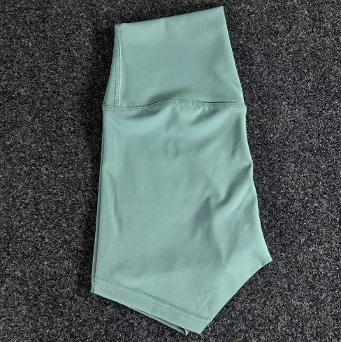 High-waisted yoga shorts in nylon fabric for moisture-wicking during sports, available in multiple colours and sizes.
