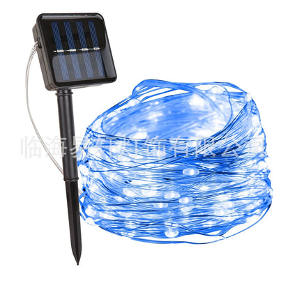 Solar-powered LED string lights arranged in garden with solar panel charging in sunlight