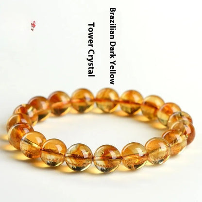 Natural yellow citrine bracelet with geometric beads in various sizes from 4mm to 20.8mm diameter on wrist