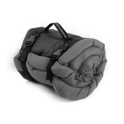 Blue foldable outdoor dog bed shown both open and folded with nylon buckles, on a grassy background.