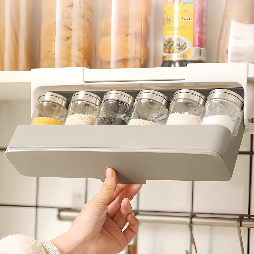 Gray kitchen storage rack with six seasoning bottles mounted on wall using punch-free adhesive system