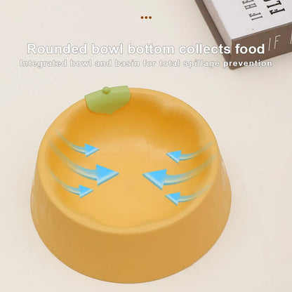 Green plastic double pet bowl with two compartments for food and water on a flat surface.