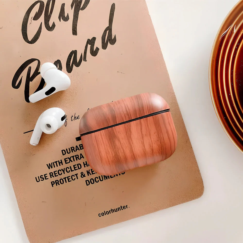 Wood grain AirPods case with IMD clamshell design showing six colour options including dark brown and red brown patterns