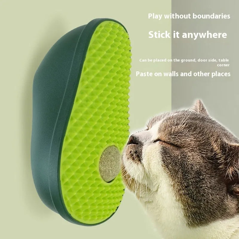 Green avocado-shaped cat toy with a central scratching post for cats.