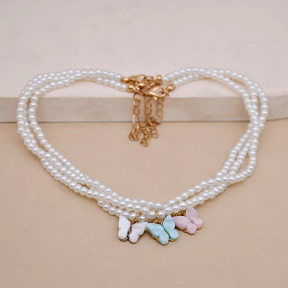 Elegant white pearl choker necklace with butterfly charm for women