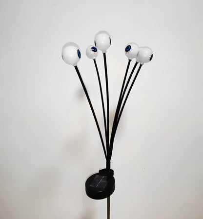 Solar-powered Halloween string lights with detailed eyeball design for outdoor garden decoration