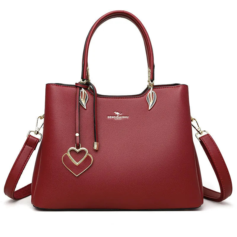 Women's black PU leather messenger bag with multi-layer shoulder strap and sewing thread detailing.