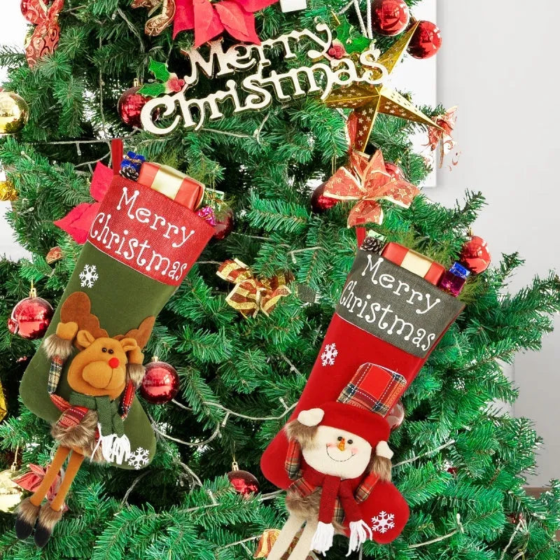Set of three large red, white, and brown Christmas stockings with 3D Santa, Snowman, and Reindeer designs hanging on a tree.