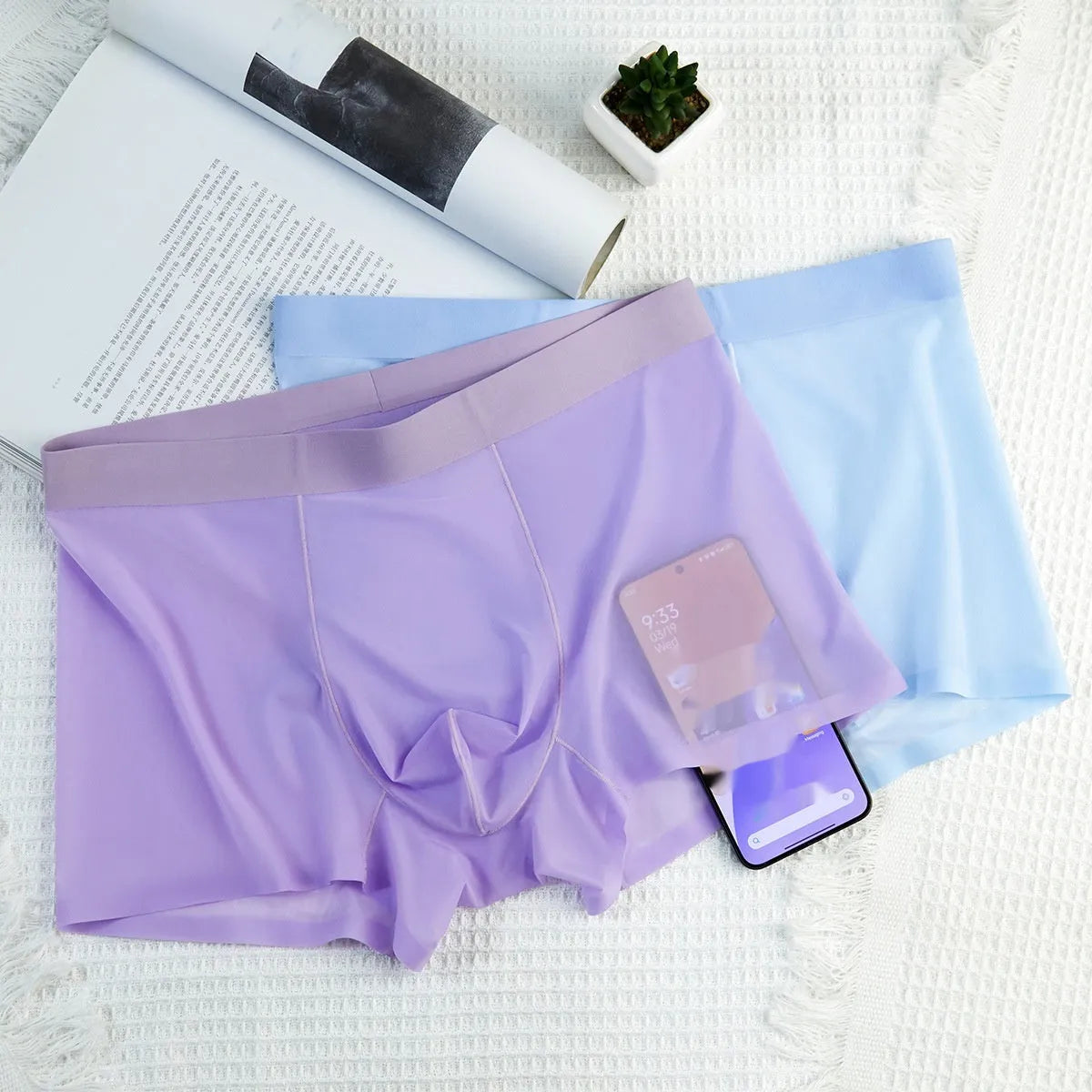Men's ultra-thin ice silk boxer briefs in purple, shown flat to highlight seamless design.