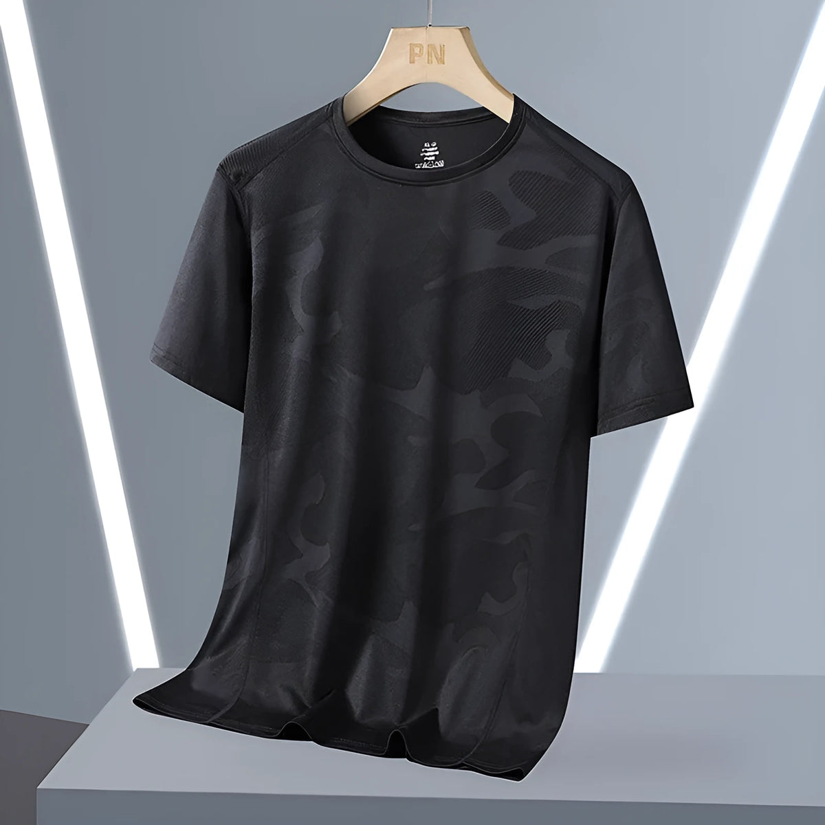 Men's loose fit camouflage nylon short sleeve summer top on a hanger