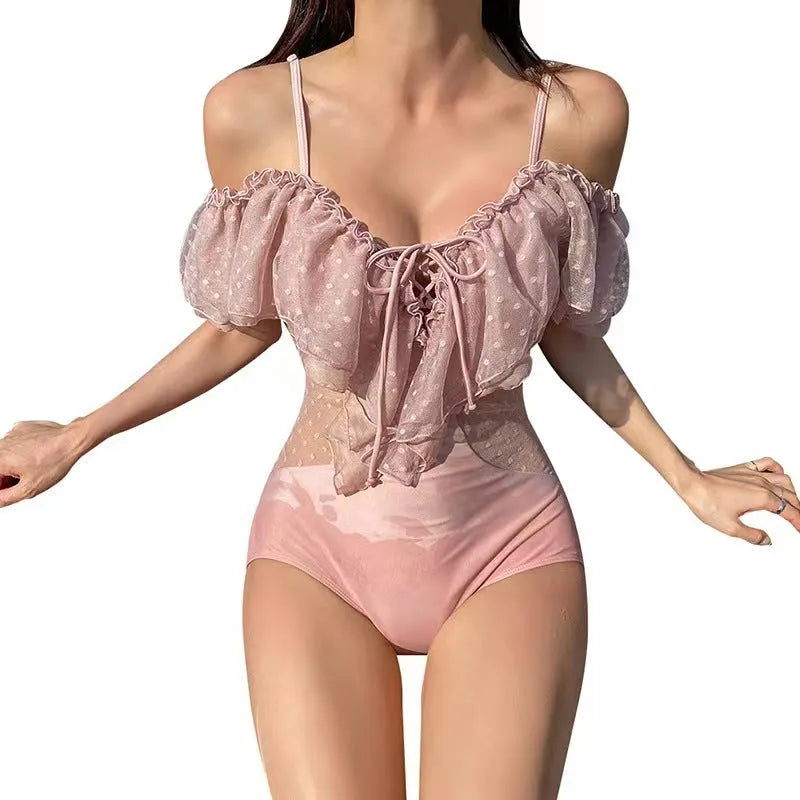Pink solid colour women's one-piece swimsuit on hanger
