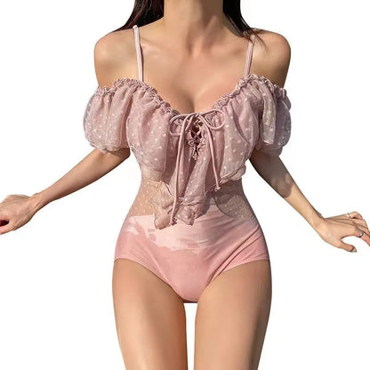 Pink solid colour women's one-piece swimsuit on hanger