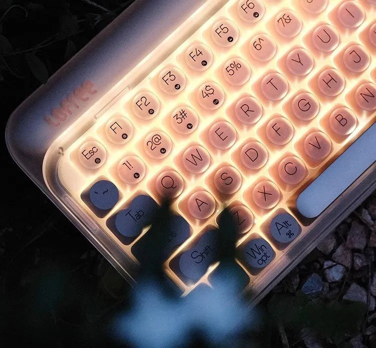 Liquid Foundation wireless mechanical keyboard with 84 keys, hot-swappable switches, Bluetooth calculator, and included mouse and light on a desk.