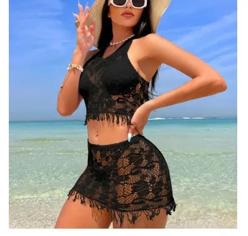 Women's white two-piece swimsuit with lace bikini top and tassel skirt on beach