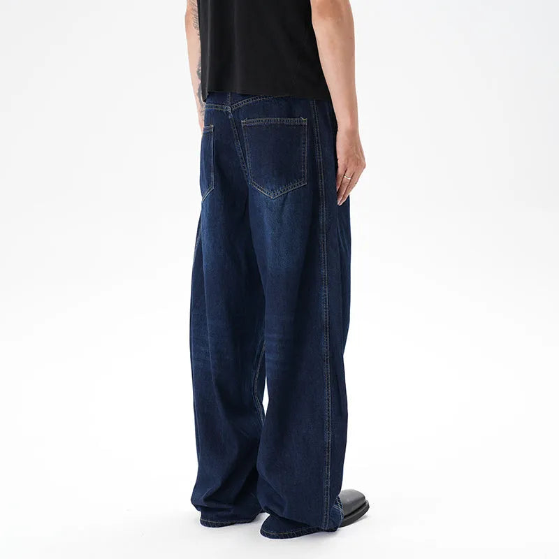 Woman wearing dark blue distressed wide leg denim jeans in a casual setting.