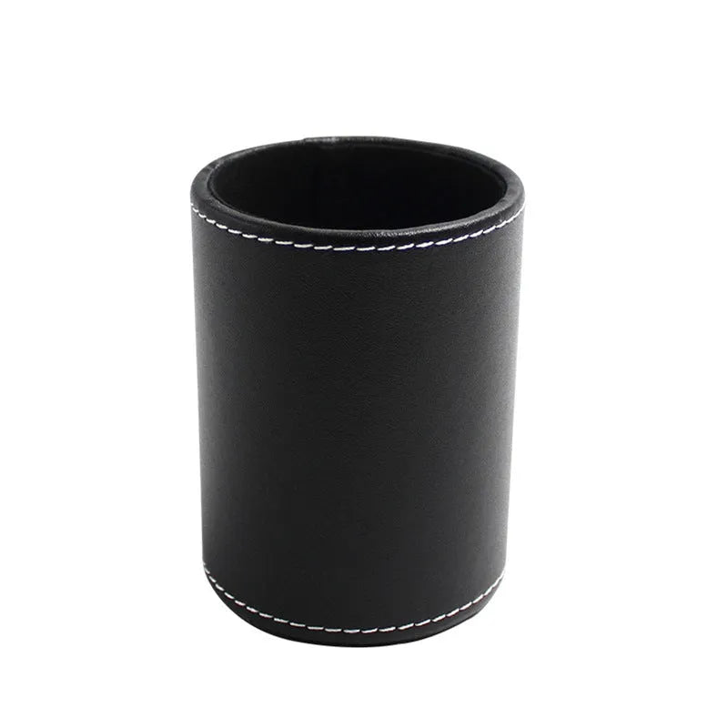 Round black leather pen container measuring 8.0cm diameter by 10.8cm height on wooden desk