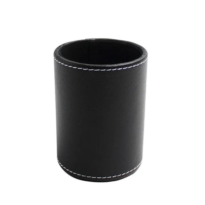 Round black leather pen container measuring 8.0cm diameter by 10.8cm height on wooden desk