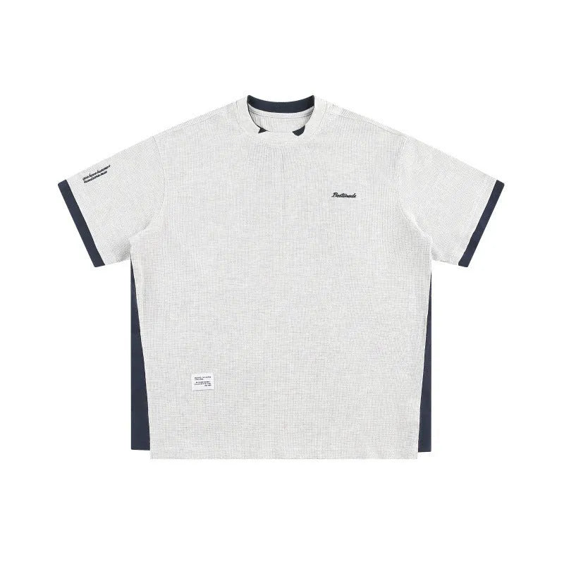 Navy blue loose waffle knit T-shirt with retro white alphabet embroidery on the chest.