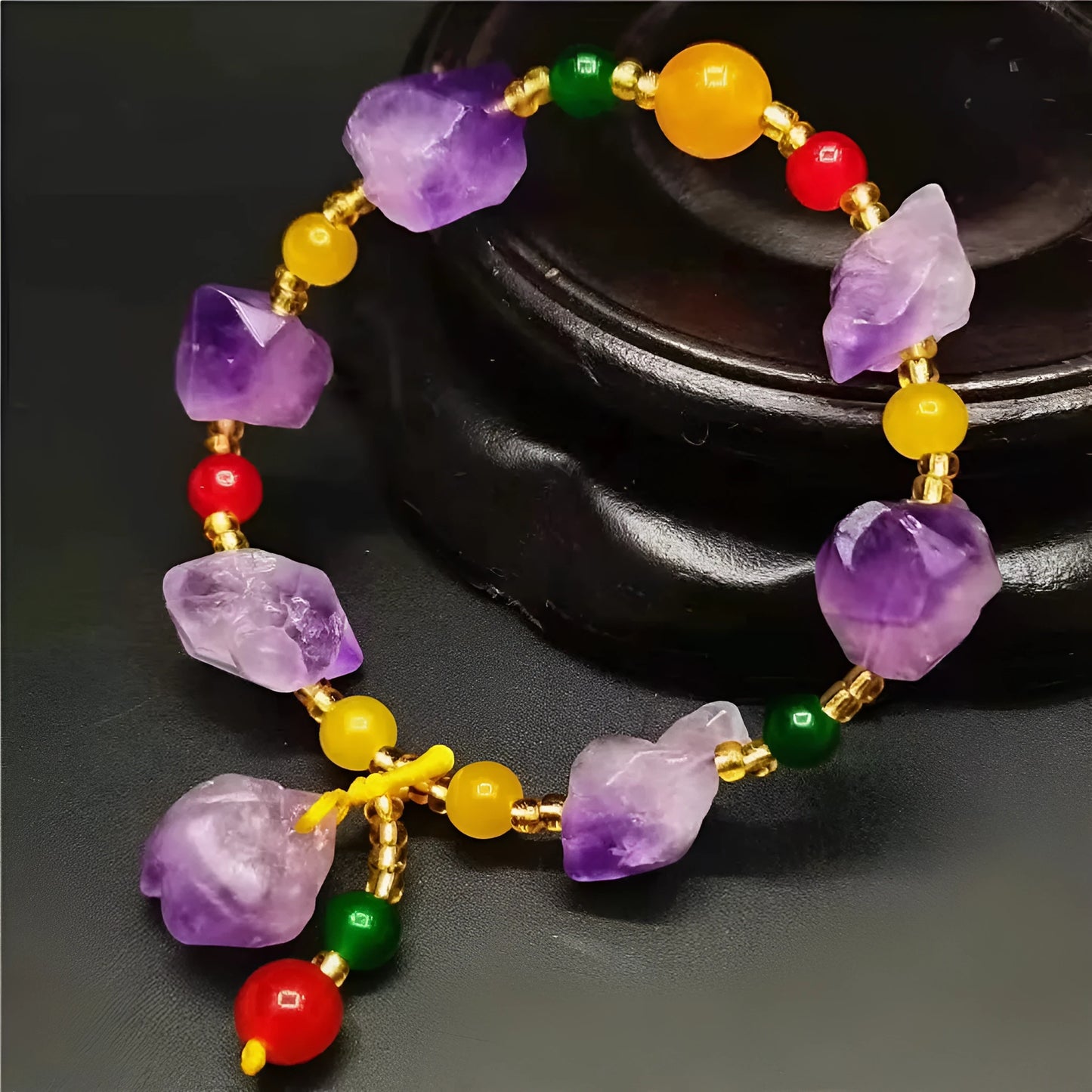 Natural shaped purple amethyst bracelet for women with a fu character bead on a white background.