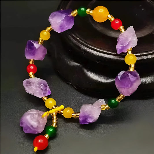 Natural shaped purple amethyst bracelet for women with a fu character bead on a white background.