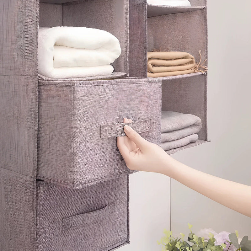 Hanging storage bag with 3-5 layer cotton fabric construction measuring 60-100cm in height, providing organised drawer storage with 24.6cm cubic compartments for wardrobe organisation
