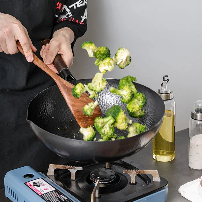 Traditional iron wok pan handmade from fine iron with 40cm diameter, heat-resistant wooden handle, induction-compatible base for even heat distribution, black colour without chemical coating