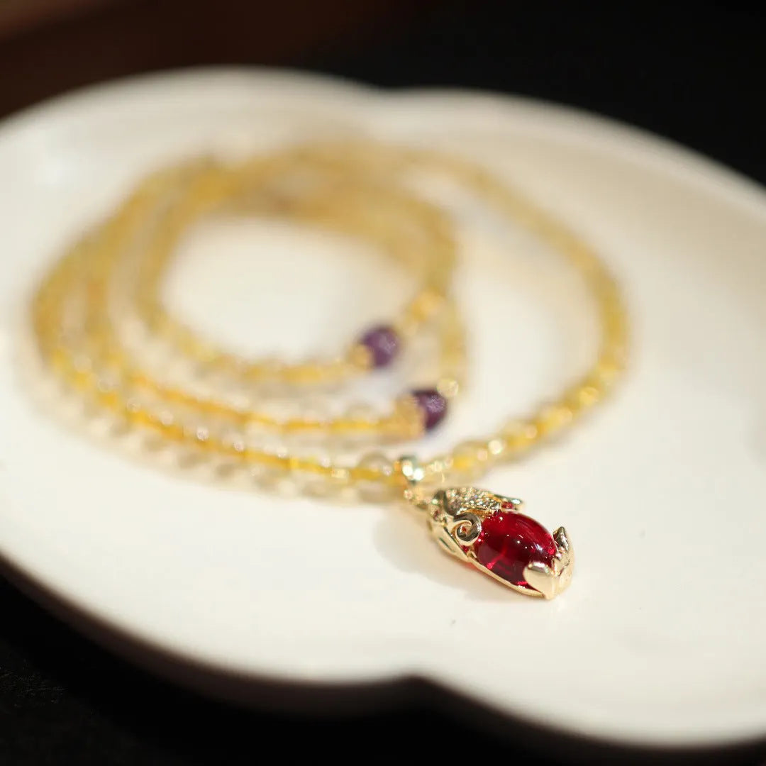 Close-up of a natural gold rutilated quartz bracelet with a Chinese style three-circle design.