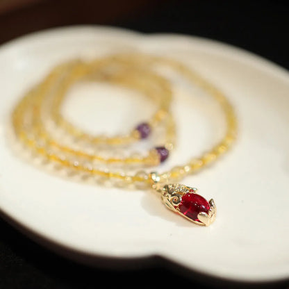 Close-up of a natural gold rutilated quartz bracelet with a Chinese style three-circle design.
