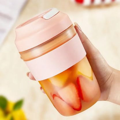 Green portable USB rechargeable blender cup with lid and four stainless steel blades, 400ml capacity.