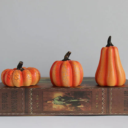 Set of three resin Halloween pumpkin lanterns with LED lights in long, medium, and short sizes.