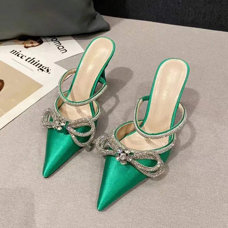 Women's black French style stiletto heel sandals with a silk back bandage and silver buckle closure.