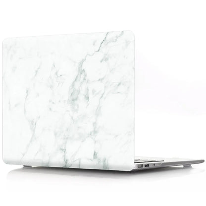 Plastic MacBook protective case in a marble pattern colour, shown next to a compatible Apple laptop.
