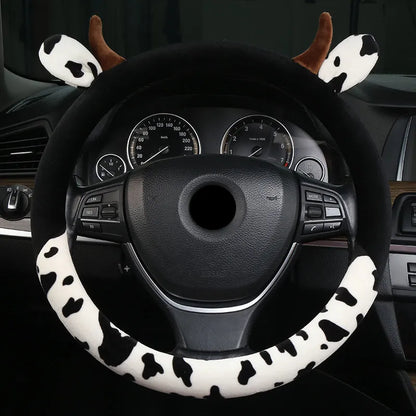 Short plush automotive steering wheel cover in black colour showing soft texture.