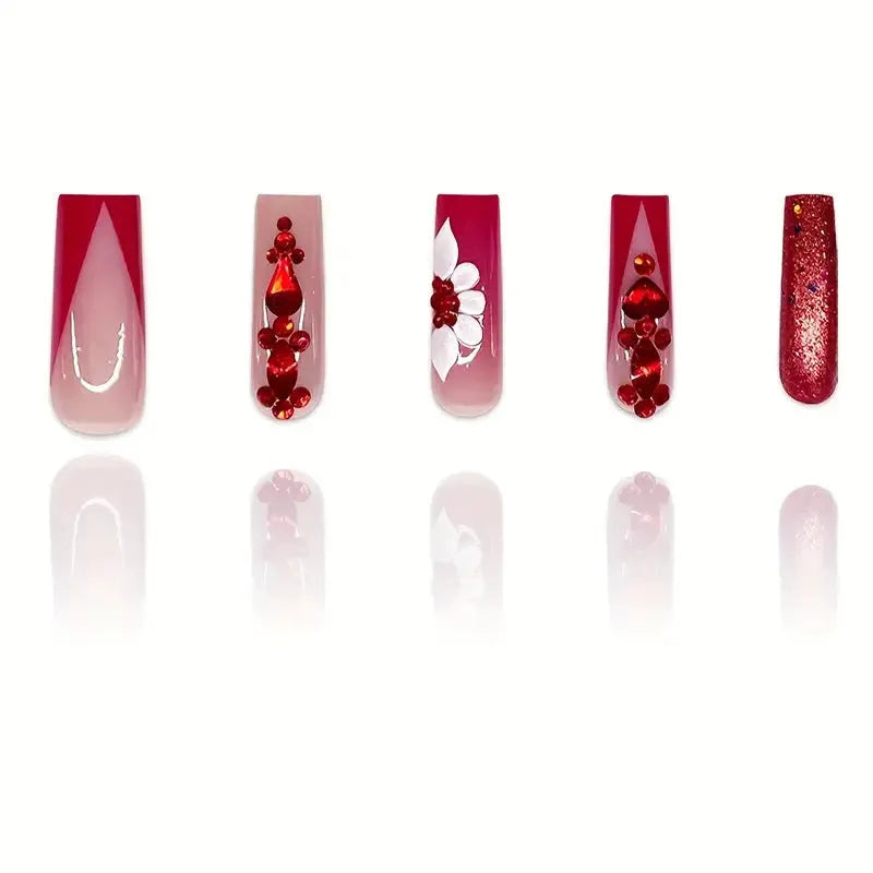 Sweet floral pattern press-on nails with red diamond accents in a long European Square shape.