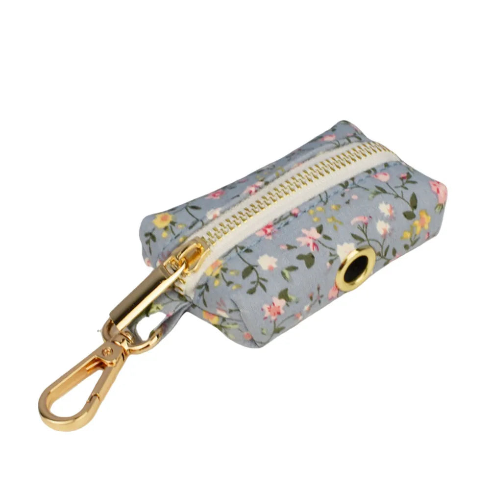 Blue floral dog collar set with adjustable sizes, includes leash, vest, bow, and poop bag on polyester cotton cloth.