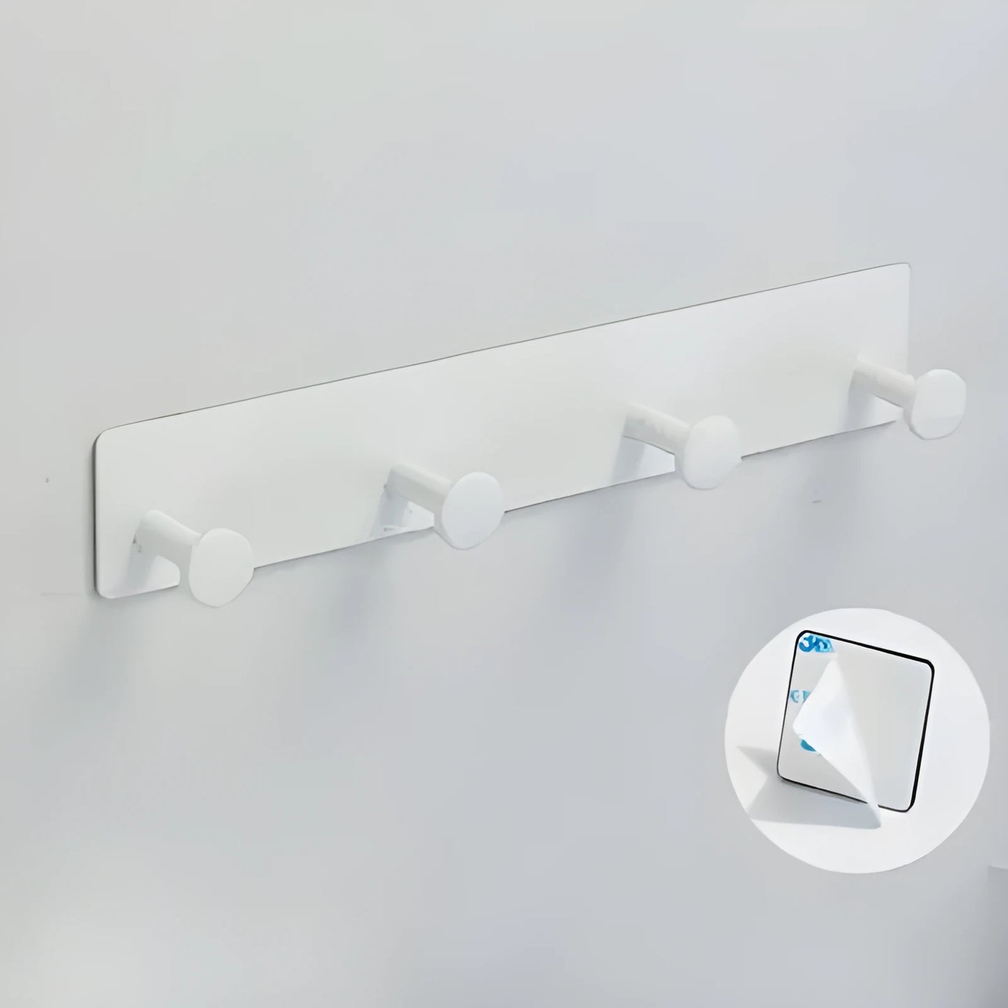 Screwless mushroom-style clothes hook with adhesive backing, shown in white on a tiled wall.
