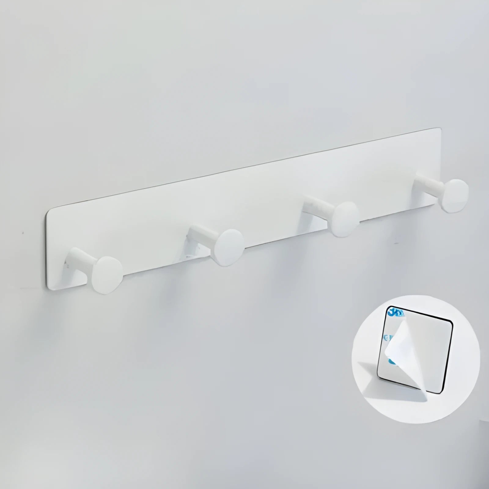 Screwless mushroom-style clothes hook with adhesive backing, shown in white on a tiled wall.