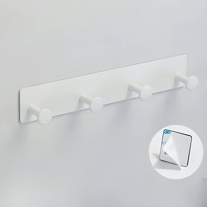 Screwless mushroom-style clothes hook with adhesive backing, shown in white on a tiled wall.