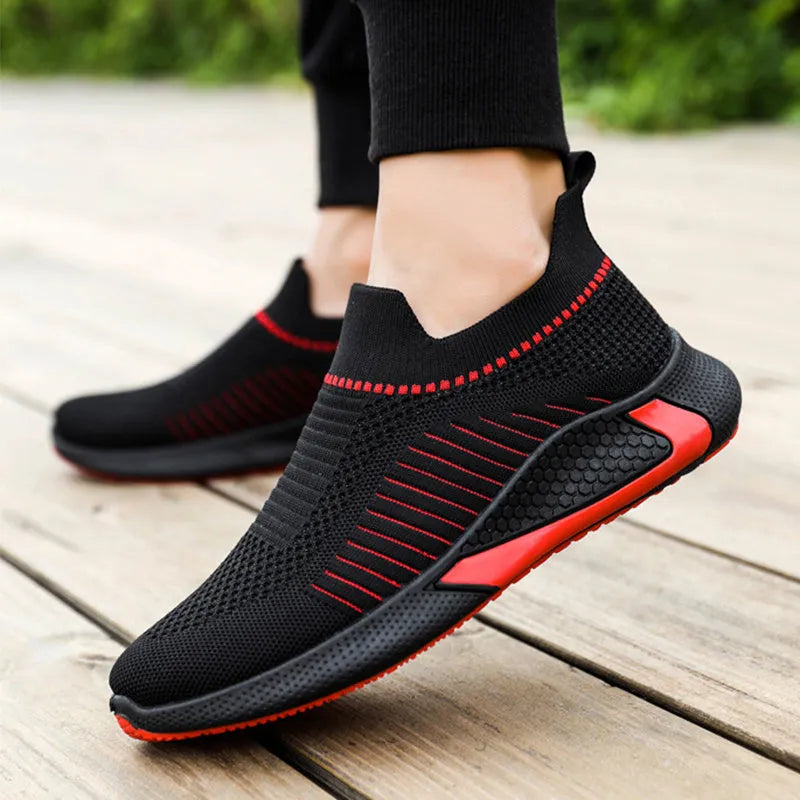 Men's black and white striped mesh slip-on sneakers with lace-up front.