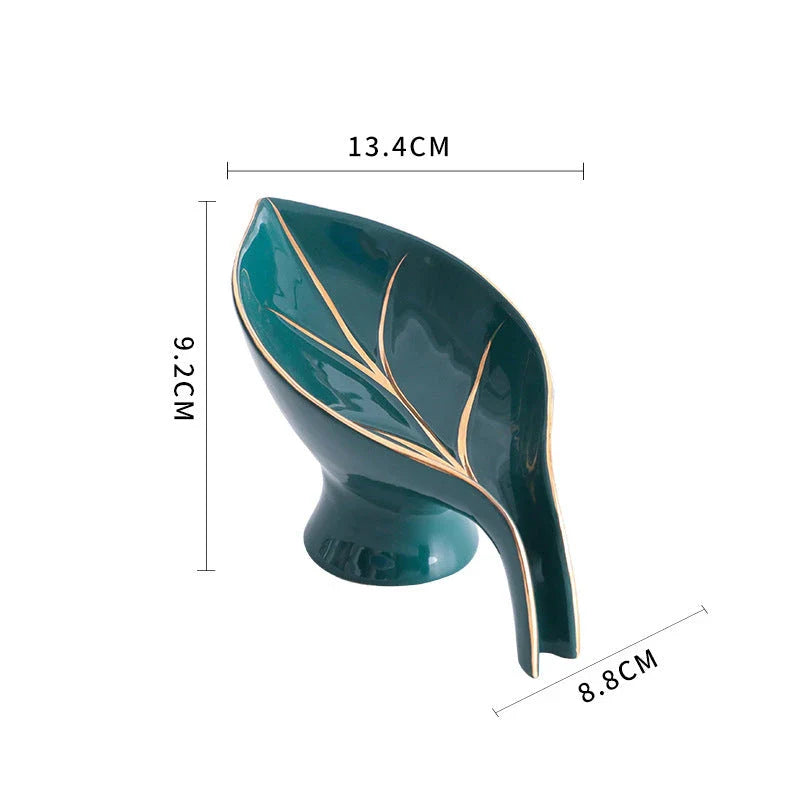 Elegant ceramic soap dish with leaf-shaped design, suction cup, and drainage holes for bathroom and kitchen use