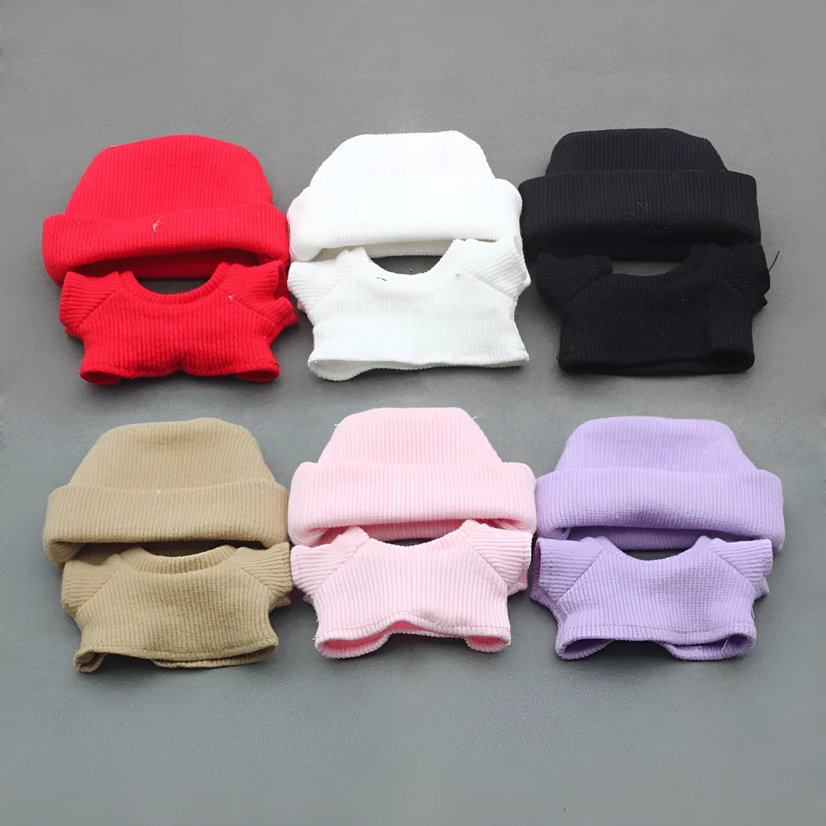 Doll clothes set with knitted flanging hat and T-shirt in multiple colours including pink, white, and stripes.