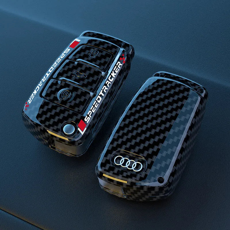 Carbon fibre style car key cover with a mirrored surface element, shown in black and white.