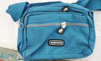 Compact nylon messenger bag in various colors with multiple compartments