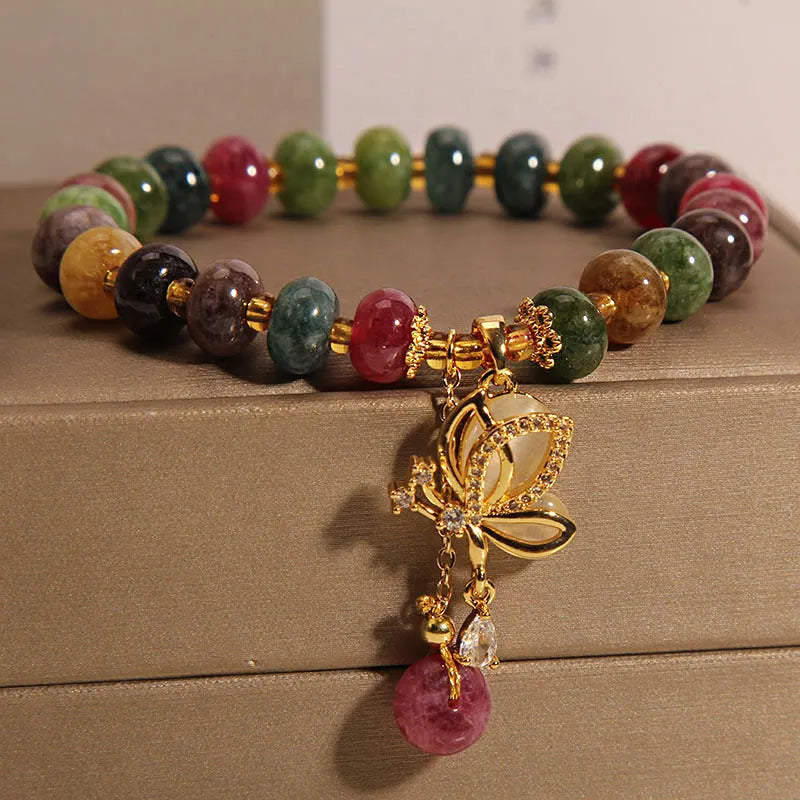 Colourful women's bracelet with butterfly charm, beads, and tourmaline accents on an alloy chain.