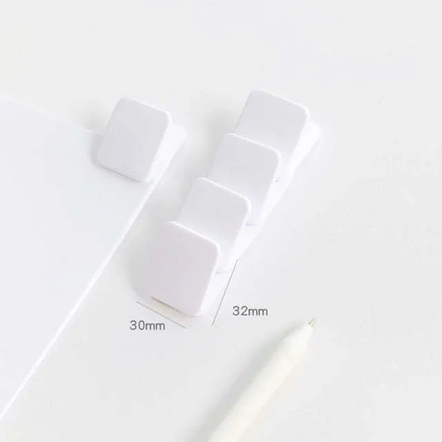 Square plastic photo holder in black, white, and transparent colour options on desk